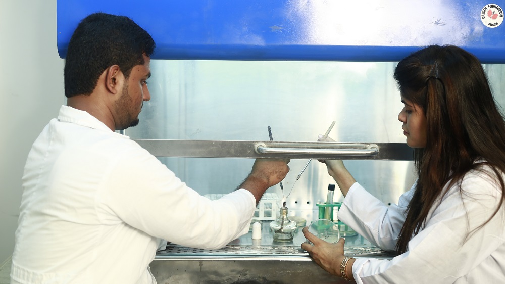 Students working at laminar flow in the laboratory.JPG
